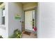 Charming entryway with a decorative sign, flamingo, and potted plants creates a welcoming ambiance at 6094 Amberly Dr, Bradenton, FL 34208