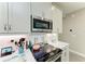 Kitchen detail showing stainless microwave and cooktop with white subway tile backsplash at 6094 Amberly Dr, Bradenton, FL 34208
