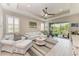 Spacious living room boasts a ceiling fan, modern furnishings, and seamless access to outdoor spaces at 6094 Amberly Dr, Bradenton, FL 34208