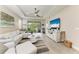Bright living room with modern furniture, ceiling fan, and sliding glass doors to the lanai at 6094 Amberly Dr, Bradenton, FL 34208