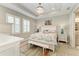 Bright main bedroom with a chandelier, shuttered windows, and decorative seashell-themed bedding at 6094 Amberly Dr, Bradenton, FL 34208