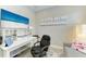 Well-lit home office with a beach-themed TV, desk, a sofa, and a ceiling fan at 6094 Amberly Dr, Bradenton, FL 34208
