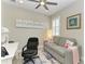 Cozy home office with gray sofa, a desk, and shuttered windows for natural light at 6094 Amberly Dr, Bradenton, FL 34208