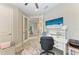 Open home office with white desk, TV, chair, and an entry to another room at 6094 Amberly Dr, Bradenton, FL 34208
