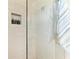 Modern walk-in shower with neutral tile, a shelf inset, and a glass wall at 6094 Amberly Dr, Bradenton, FL 34208