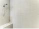 Walk-in shower featuring neutral tile, a built-in bench, and a wall-mounted shower head at 6094 Amberly Dr, Bradenton, FL 34208