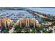Aerial view showcases waterfront condos with marina, beautiful landscaping, and water views at 610 Riviera Dunes Way # 308, Palmetto, FL 34221