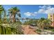 Balcony view showcasing a bridge, waterway and palm trees under a bright sky at 610 Riviera Dunes Way # 308, Palmetto, FL 34221