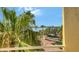 Scenic balcony view with palm trees, waterway, and a glimpse of the city skyline at 610 Riviera Dunes Way # 308, Palmetto, FL 34221