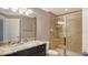 Bathroom featuring a granite vanity top and glass-enclosed shower at 610 Riviera Dunes Way # 308, Palmetto, FL 34221