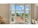 Bay window with decorative shutters provides a beautiful view of tropical landscape and blue sky at 610 Riviera Dunes Way # 308, Palmetto, FL 34221