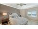 Comfortable bedroom featuring a bed, a nightstand with lamp and a window that provides natural light at 610 Riviera Dunes Way # 308, Palmetto, FL 34221