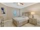Comfortable bedroom with modern furniture, natural light, and tiled flooring at 610 Riviera Dunes Way # 308, Palmetto, FL 34221