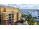 Exterior view of condo building overlooking a marina filled with boats and yachts at 610 Riviera Dunes Way # 308, Palmetto, FL 34221