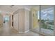 Hallway leading to a balcony with bright light, beige walls and views to waterway at 610 Riviera Dunes Way # 308, Palmetto, FL 34221