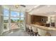 Eat-in kitchen with granite counters, stainless appliances, a large view window, and bar seating at 610 Riviera Dunes Way # 308, Palmetto, FL 34221