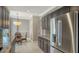Kitchen with stainless steel refrigerator and a dining area featuring rattan chairs at 610 Riviera Dunes Way # 308, Palmetto, FL 34221