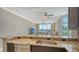 Kitchen with breakfast bar offering living area views and stainless steel appliances at 610 Riviera Dunes Way # 308, Palmetto, FL 34221