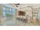 Open living area with bar seating, shutters, and views to the kitchen and hall at 610 Riviera Dunes Way # 308, Palmetto, FL 34221