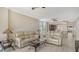 Inviting living room with view into kitchen, tile floors, and comfortable seating at 610 Riviera Dunes Way # 308, Palmetto, FL 34221