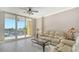 Bright living room with balcony offering beautiful marina views and comfortable seating at 610 Riviera Dunes Way # 308, Palmetto, FL 34221