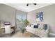 Bright living room featuring modern decor, desk area, and large window with natural light at 610 Riviera Dunes Way # 308, Palmetto, FL 34221
