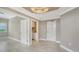 Bright living room with tiled floors, chandelier and laundry room with easy access at 610 Riviera Dunes Way # 308, Palmetto, FL 34221