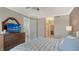 Well-lit main bedroom with neutral colors, and a dark dresser with a vanity mirror at 610 Riviera Dunes Way # 308, Palmetto, FL 34221