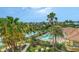 Balcony view overlooking community pool, palm trees, and waterway on a bright day at 610 Riviera Dunes Way # 308, Palmetto, FL 34221