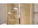 Shower featuring tile surround, rainfall shower head, and built-in bench at 610 Riviera Dunes Way # 308, Palmetto, FL 34221