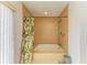 Updated bathroom features tile surround soaking tub with shower and tropical decor at 6101 34Th W St # 28E, Bradenton, FL 34210