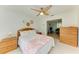 Bright bedroom featuring a ceiling fan, white walls, and a glimpse into the living area at 6101 34Th W St # 28E, Bradenton, FL 34210