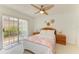 Cozy bedroom features a ceiling fan, and sliding glass doors that lead to the outdoors at 6101 34Th W St # 28E, Bradenton, FL 34210