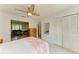 Bedroom with white walls, ceiling fan, closet, and view into living area at 6101 34Th W St # 28E, Bradenton, FL 34210