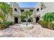 Inviting courtyard featuring a decorative fountain, tropical landscaping, and charming brick pavers leading to the entrances at 6101 34Th W St # 28E, Bradenton, FL 34210