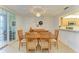 Inviting dining room with modern lighting, patio access, and a seamless flow into the kitchen at 6101 34Th W St # 28E, Bradenton, FL 34210
