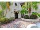 Elegant entrance with lush landscaping and a brick paved walkway leading to a charming, well-maintained home at 6101 34Th W St # 28E, Bradenton, FL 34210