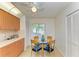 Eat-in kitchen area features glass table, light wood cabinetry, tan tile floors, and ample storage at 6101 34Th W St # 28E, Bradenton, FL 34210
