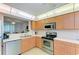 Updated kitchen features stainless appliances, light wood cabinetry, and tile floor at 6101 34Th W St # 28E, Bradenton, FL 34210