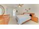 Bedroom with light carpet, ceiling fan, light wood furniture, and updated lighting at 6101 34Th W St # 28E, Bradenton, FL 34210