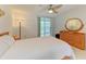 Bedroom with light carpet, ceiling fan, light wood furniture, and sliding glass door to outdoor area at 6101 34Th W St # 28E, Bradenton, FL 34210