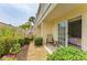 Charming patio area with lush garden and comfortable seating, viewed through the sliding door into the bedroom at 6101 34Th W St # 28E, Bradenton, FL 34210