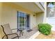 Inviting patio with tiled flooring, outdoor seating, and view of garden area through sliding glass door at 6101 34Th W St # 28E, Bradenton, FL 34210