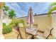 Outdoor patio area features seating area with table, umbrella, and tropical landscaping at 6101 34Th W St # 28E, Bradenton, FL 34210