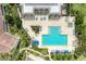 Overhead view of the community pool area featuring ample seating, pool, hot tub and landscaping at 6101 34Th W St # 28E, Bradenton, FL 34210