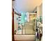 Bathroom with a shower-tub combo, storage shelves, and tiled walls at 6265 Viola Ln, New Port Richey, FL 34653