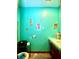 Bathroom with a sink, a toilet, and decorated teal walls with pineapples at 6265 Viola Ln, New Port Richey, FL 34653