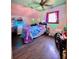 Cozy bedroom featuring sloped ceiling, wood floors, and window with curtains at 6265 Viola Ln, New Port Richey, FL 34653