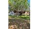 Charming home exterior featuring mature shade trees and a large lawn at 6265 Viola Ln, New Port Richey, FL 34653