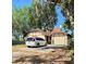 Charming single-story home with a well-maintained lawn and a private driveway with a white van at 6265 Viola Ln, New Port Richey, FL 34653